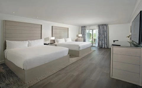 a room with two beds and a wood floor