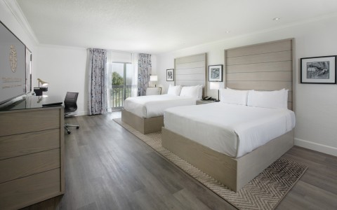 a room with two beds and a desk