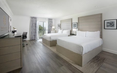 a room with two beds and a desk