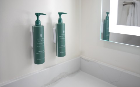 a green bottles of liquid on a wall