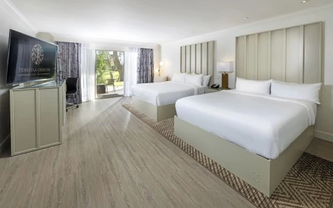 a room with two beds and a desk