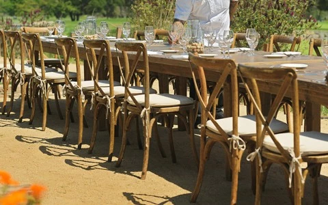 a man standing at a long table with chairs