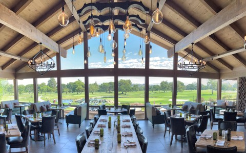 a room with a large window and a golf course view
