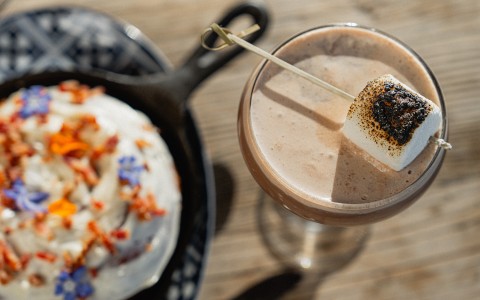 a drink with a marshmallow on a stick