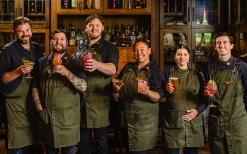 a group of people holding drinks