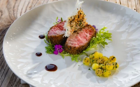 a plate of food on a wood table