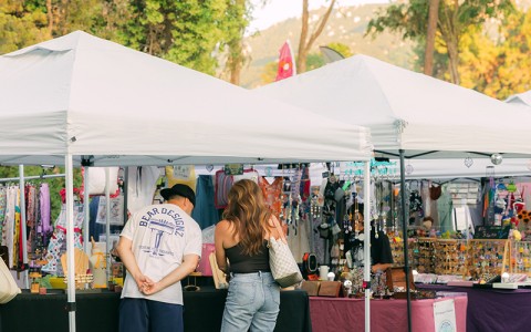 a couple of people standing under a tent