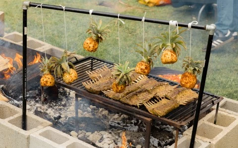 food on a grill with pineapples from it