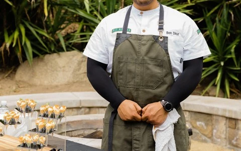 a man standing in front of a table with food