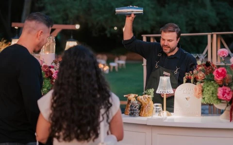 a man holding a shaker over a bar