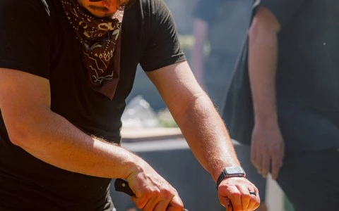 a man cutting meat on a table