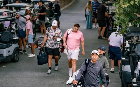 a group of people walking with golf clubs