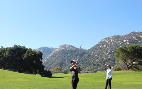 a man and woman playing golf