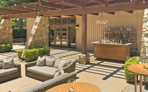 a patio with a bar and a table