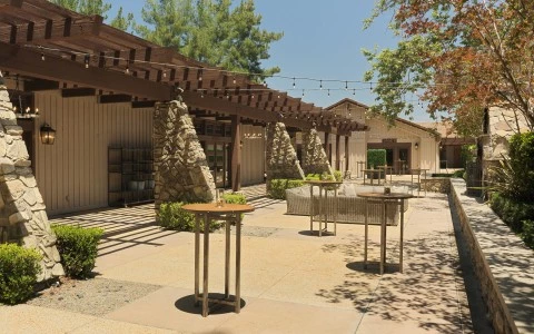 a patio with tables and chairs