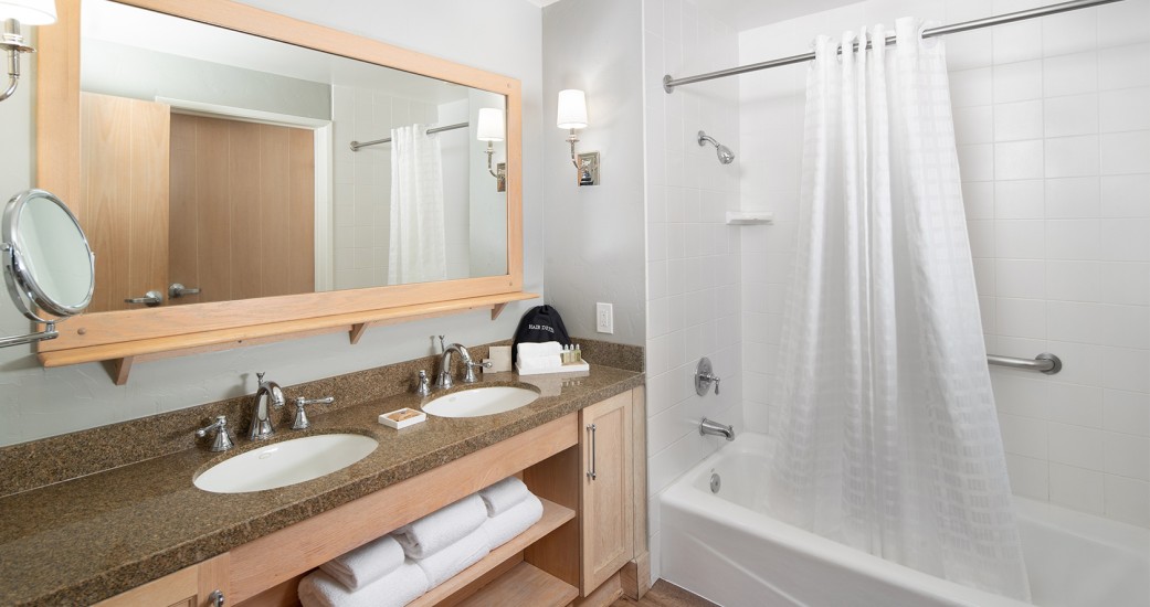 a bathroom with a mirror and a bathtub
