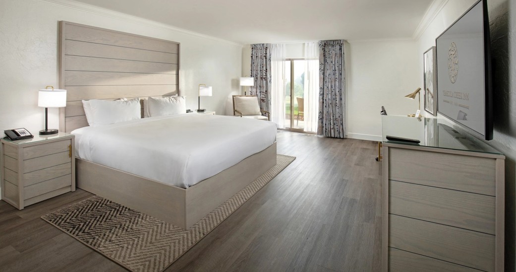 a room with a bed and a wood floor