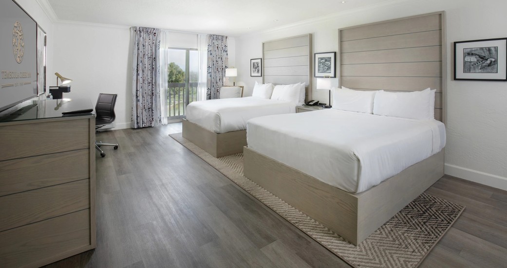 a room with two beds and a piano