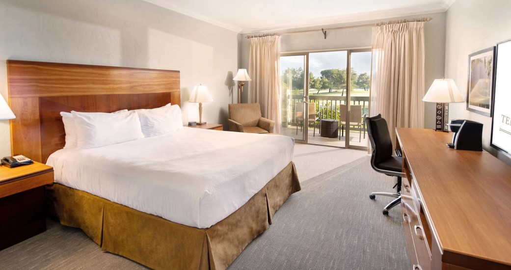 a room with a bed and a desk and chair