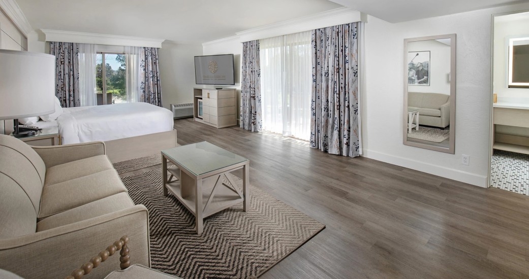 a room with a bed and a television