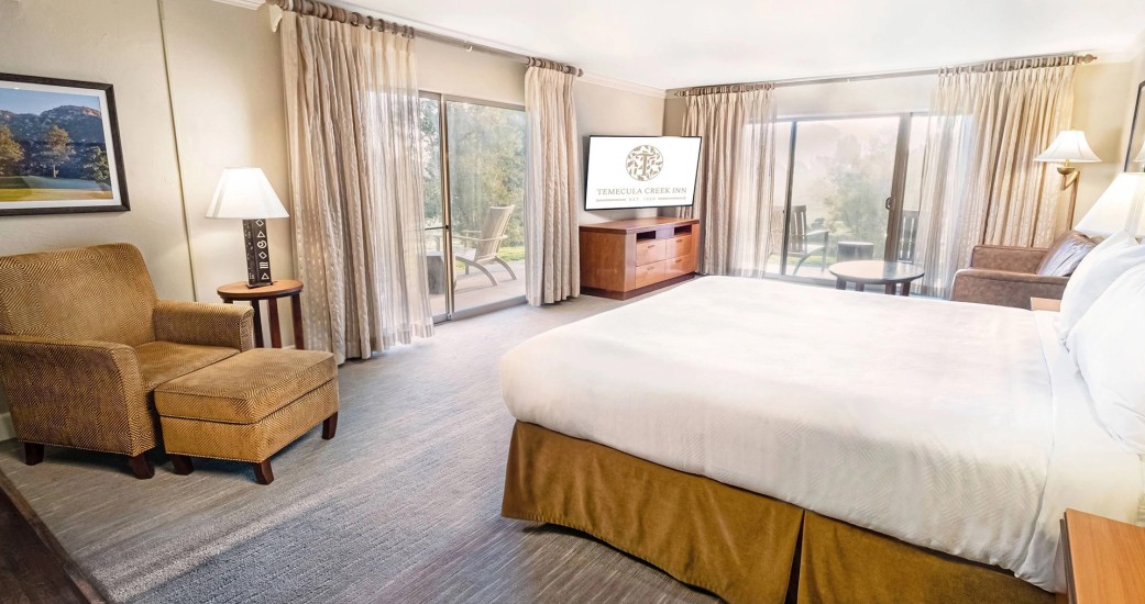 a bedroom with a television and a table