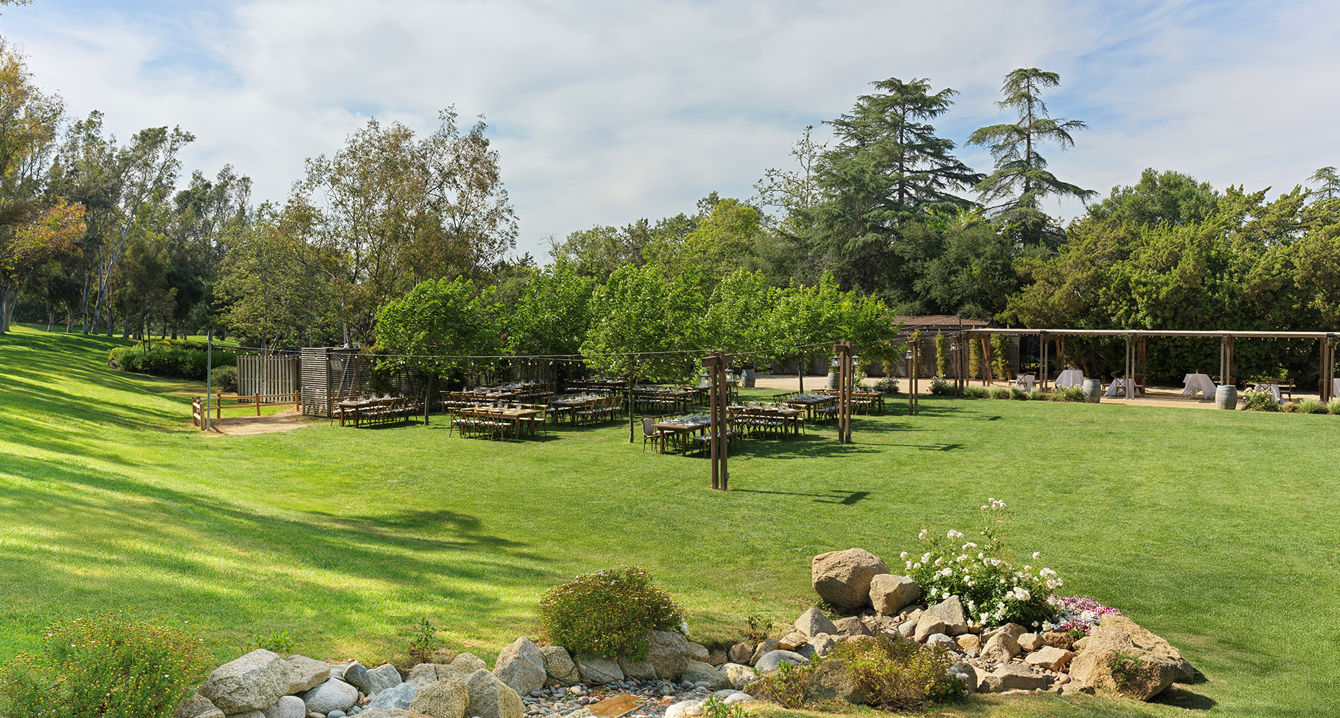 a group of tables and chairs in a grassy area
