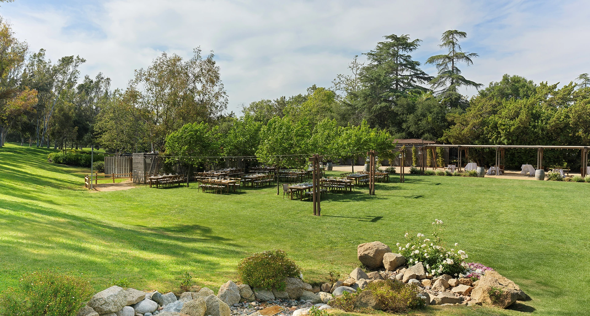 a group of tables and chairs in a grassy area