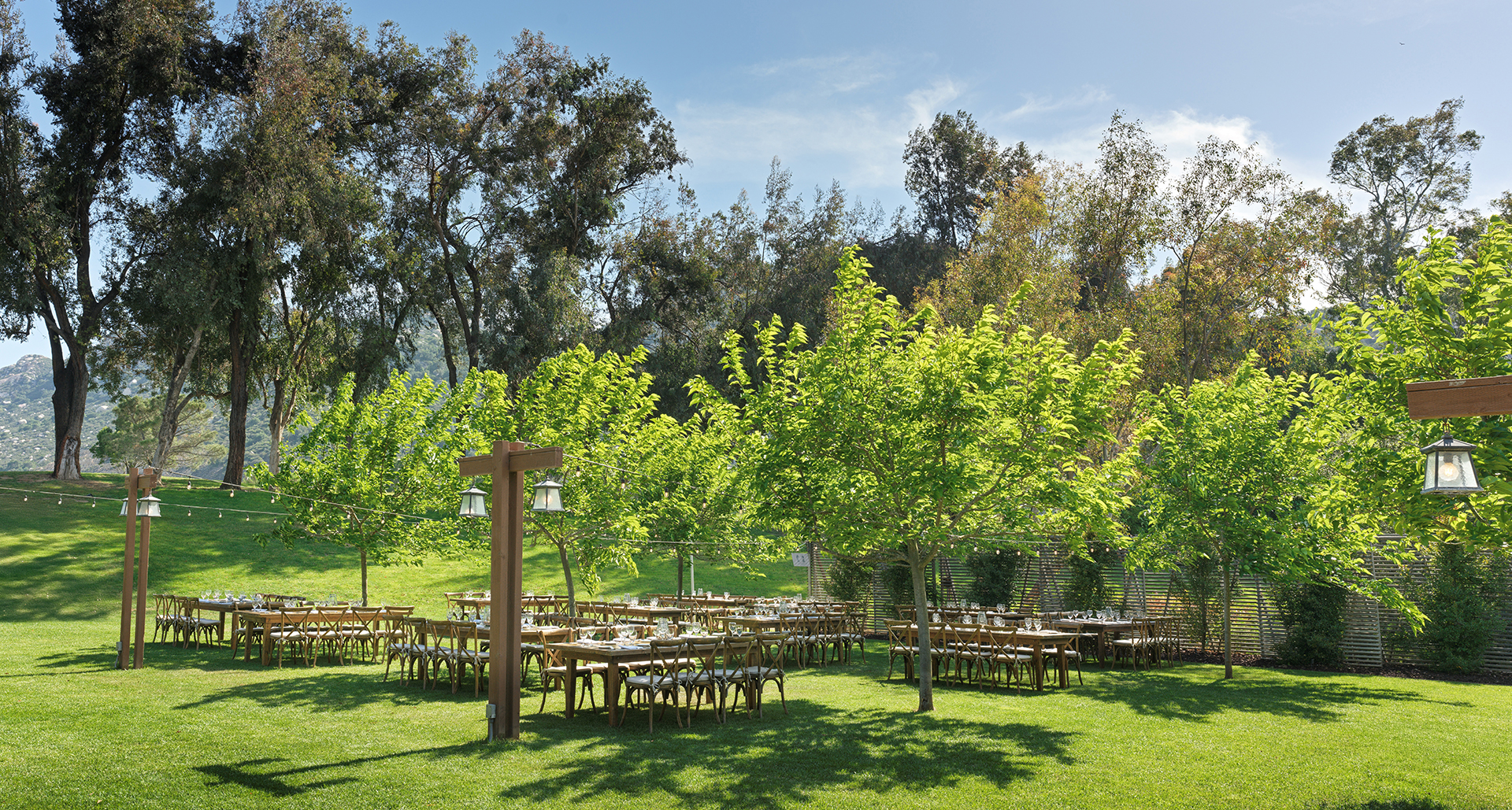 a group of tables in a grassy area