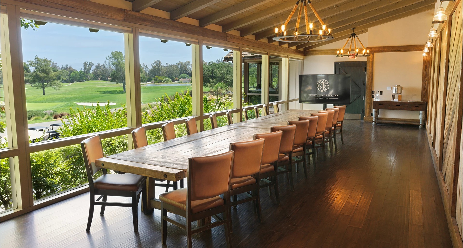a room with a long table and chairs