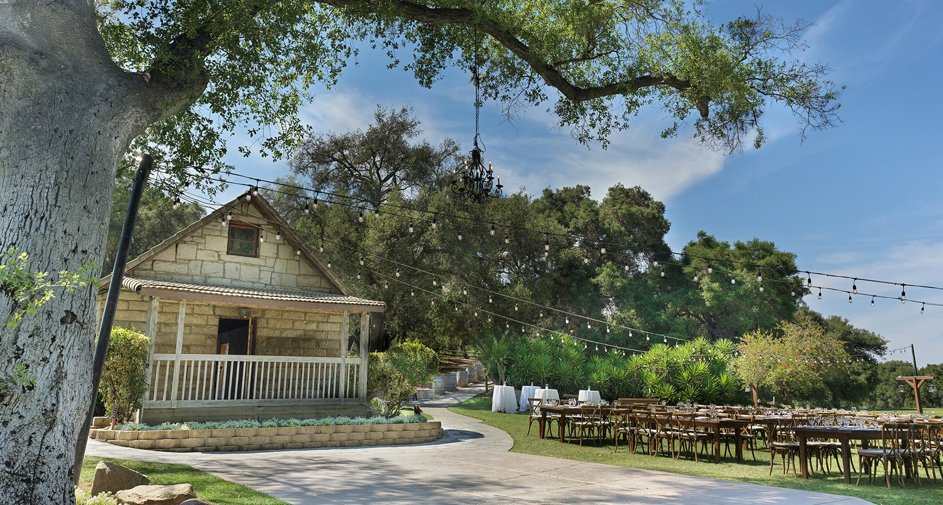 a house with tables and chairs outside