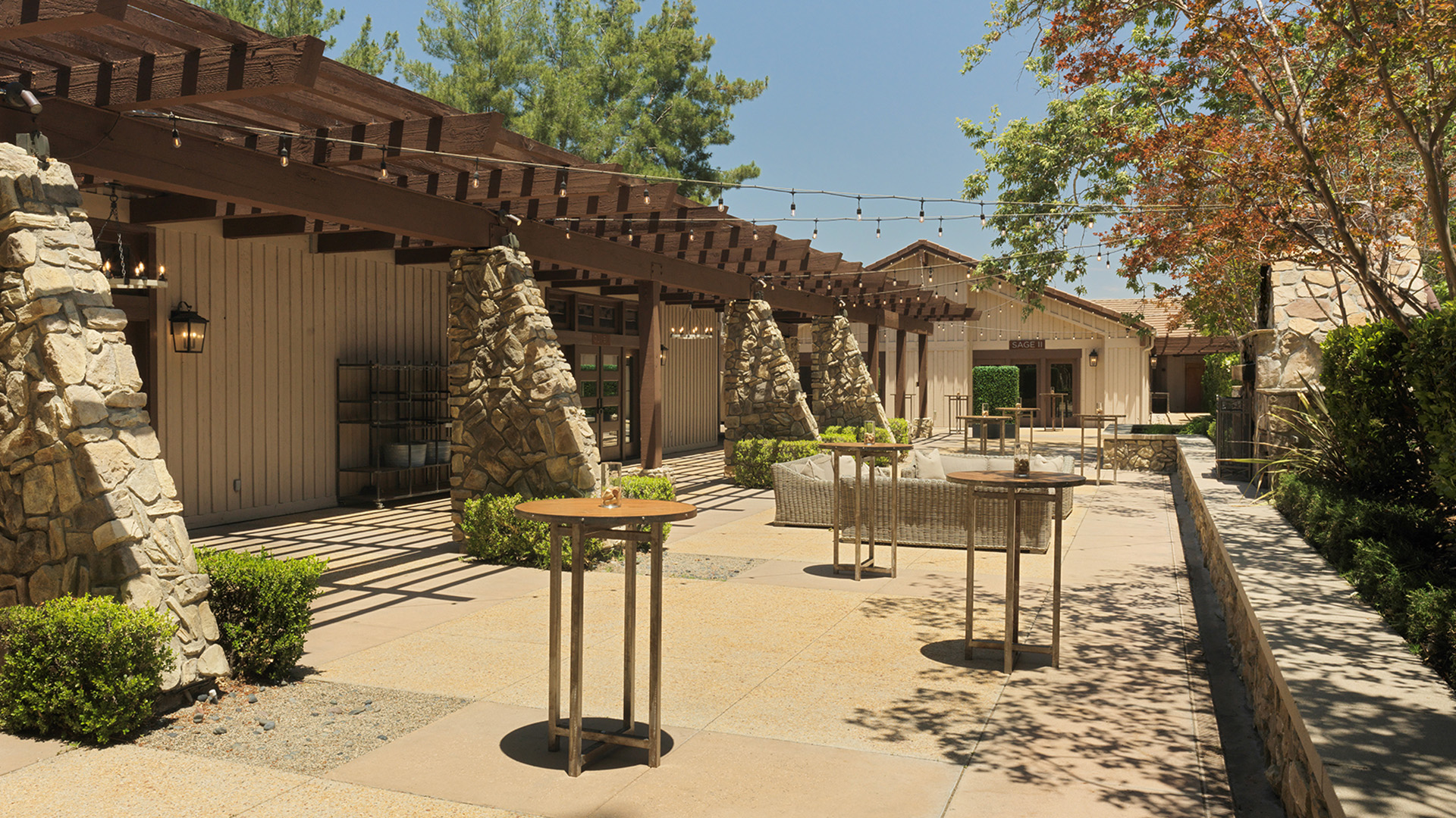 a patio with tables and chairs