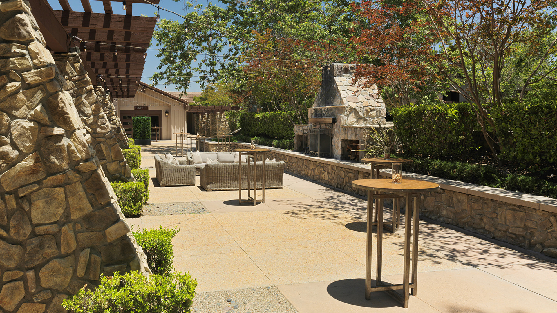 a patio with tables and chairs