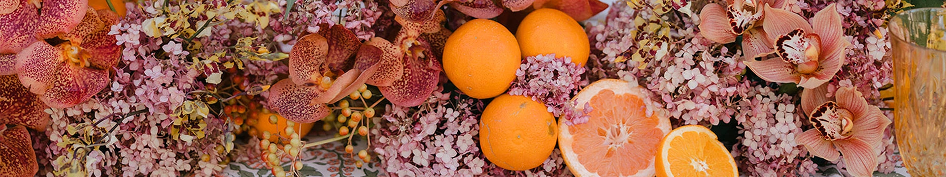 oranges and flowers on a plant