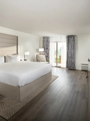 a bedroom with a large bed and a dresser