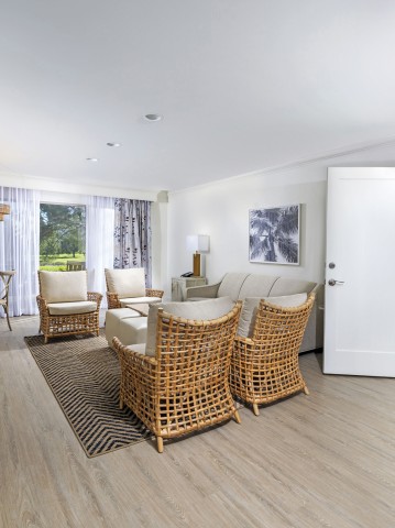 a room with a couch and chairs