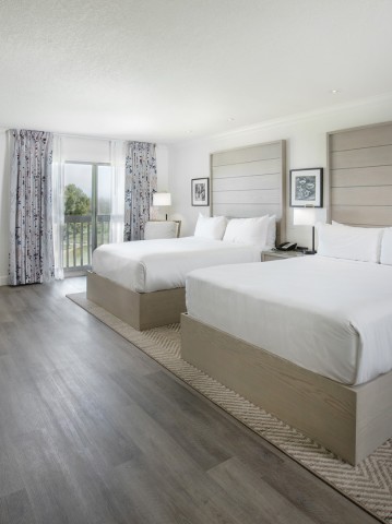 a room with two beds and a desk