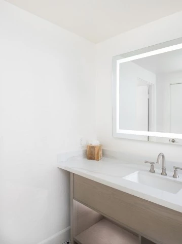 a bathroom with a mirror and sink