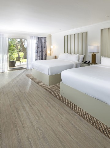 a room with two beds and a desk