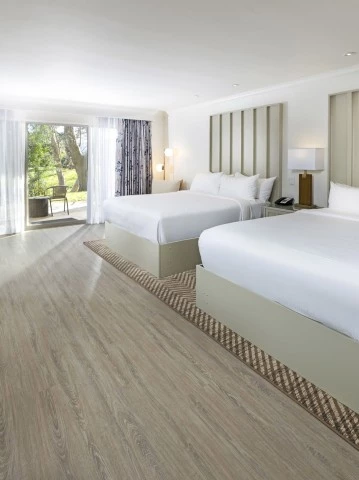 a room with two beds and a desk