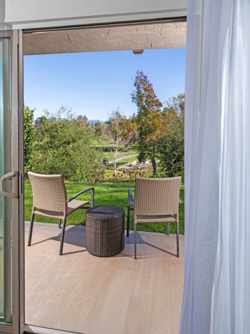 a patio with chairs and a table