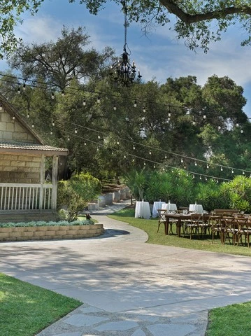 a house with tables and chairs outside
