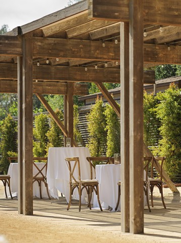 a table and chairs under a covered patio