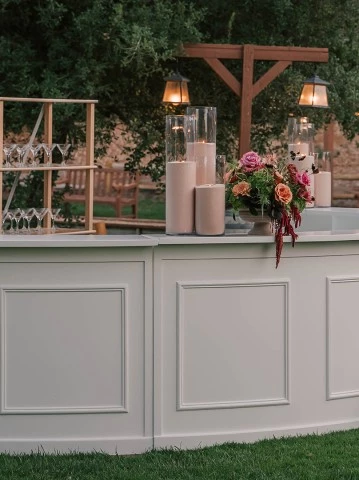 a white bar with candles and flowers