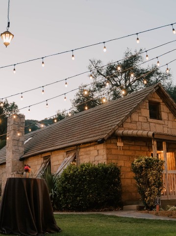 a house with a table and string of lights
