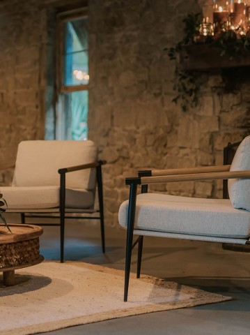 a room with a fireplace and chairs