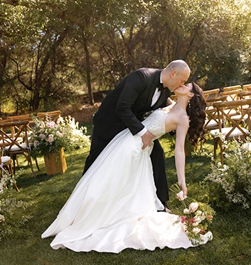 a man and woman kissing in a garden