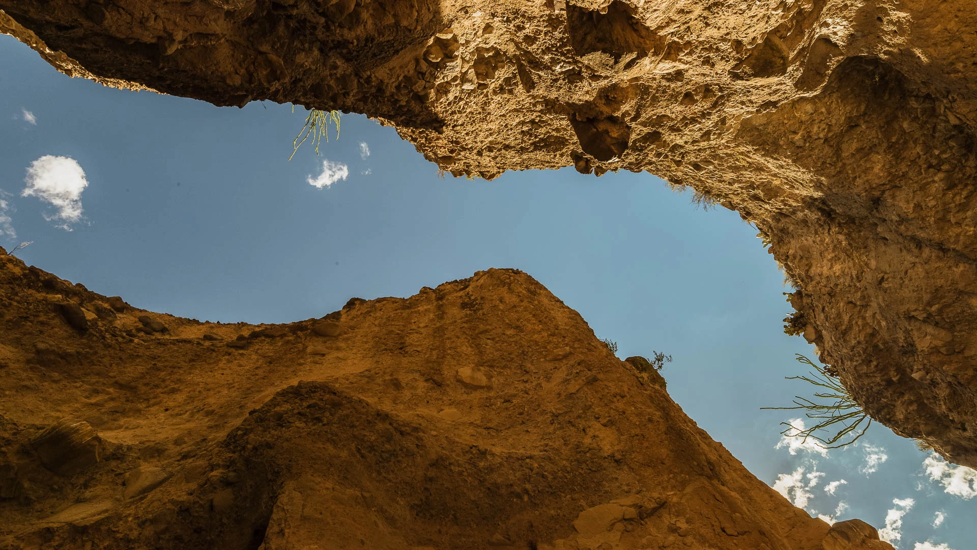 a view looking up at a rock formation