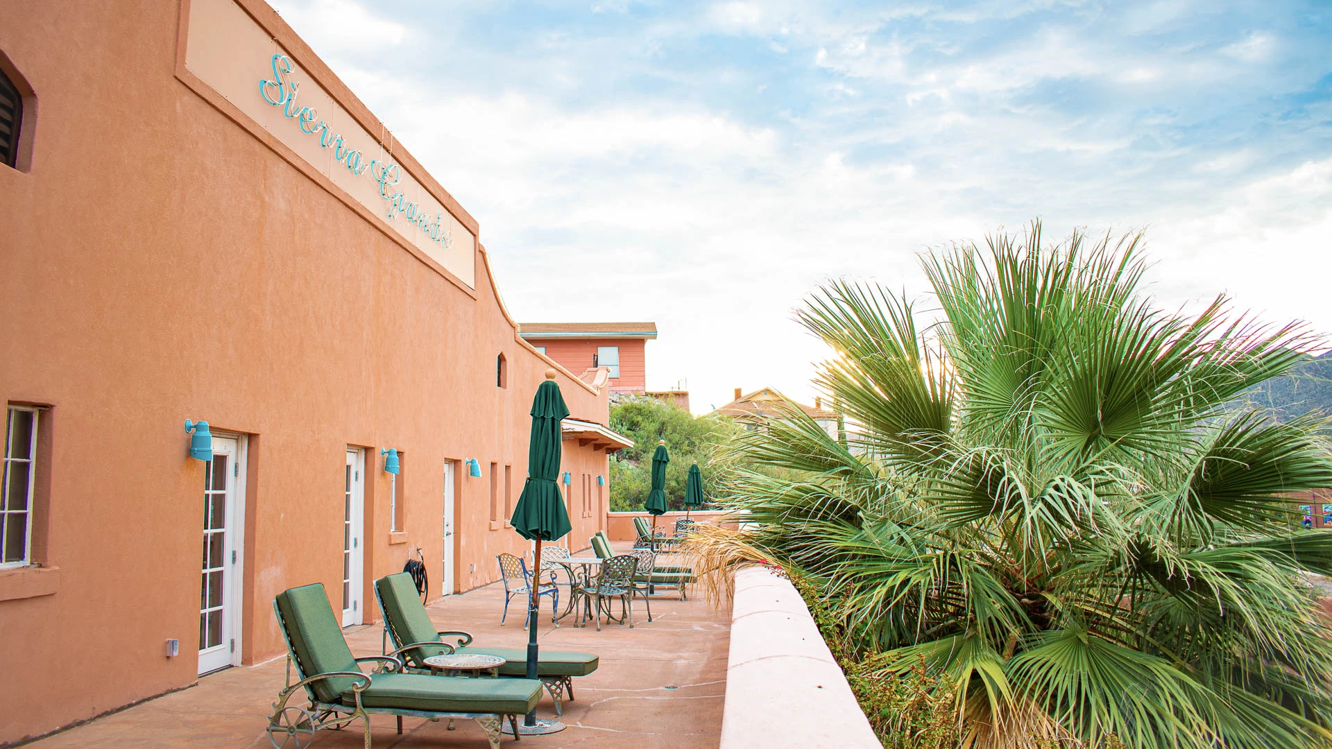 a patio with chairs and umbrellas