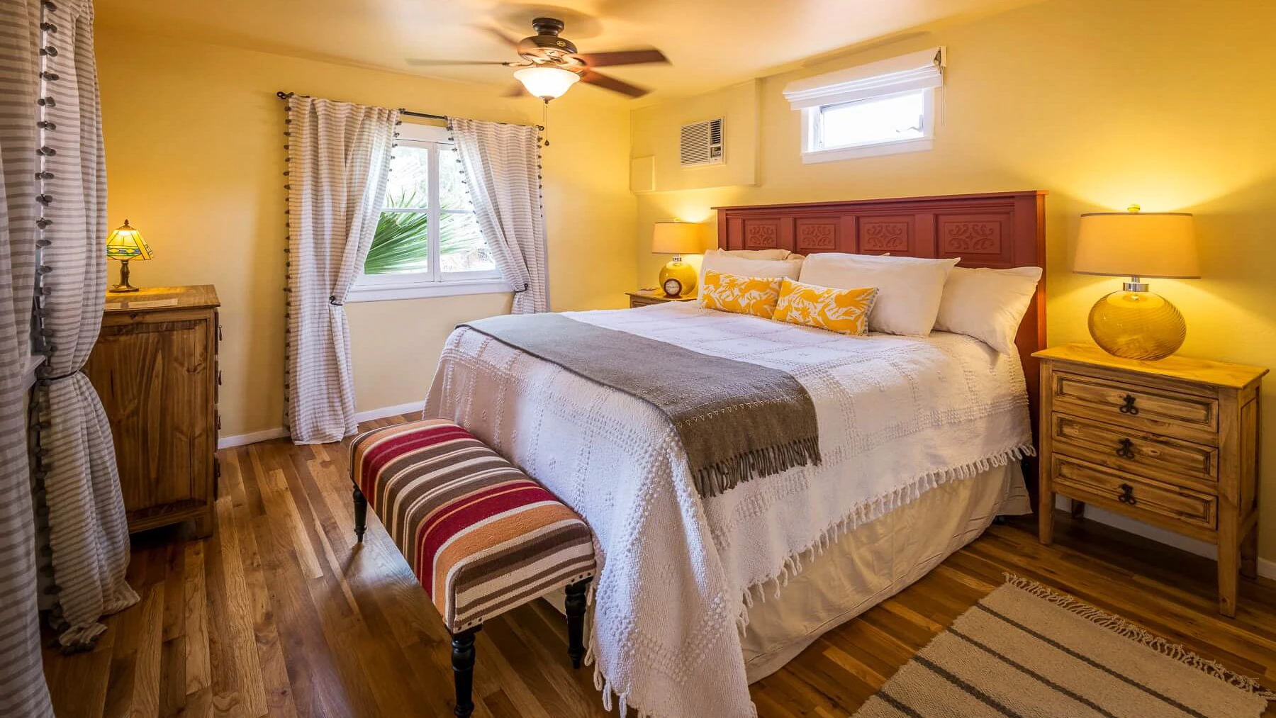 a bedroom with a bed and a fan