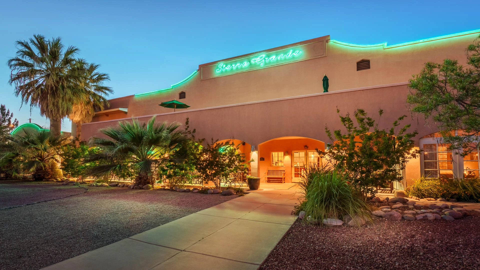 a building with palm trees and a walkway